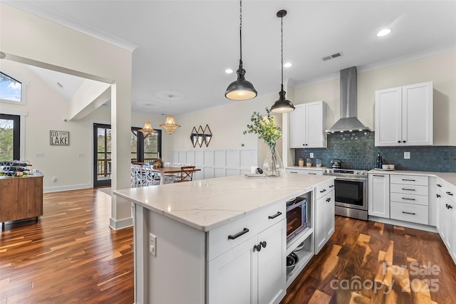 1289 Northview Dr, Morganton, NC 28655 - kitchen featuring a center island, hanging light fixtures, tasteful backsplash, stainless steel appliances, and wall chimney exhaust hood