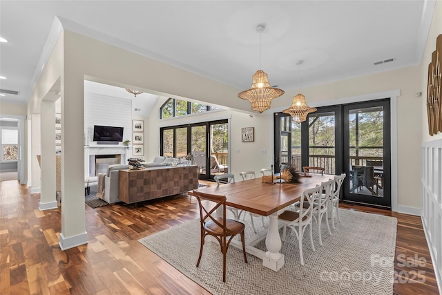 1289 Northview Dr, Morganton, NC 28655 - dining space featuring a glass covered fireplace, french doors, baseboards, dark wood-type flooring, and visible vents