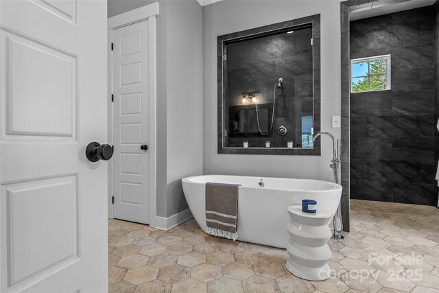 1289 Northview Dr, Morganton, NC 28655 - bathroom featuring a walk in shower, a freestanding tub, and baseboards