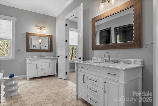 1289 Northview Dr, Morganton, NC 28655 - bathroom with baseboards, a sink, two vanities, and ornamental molding