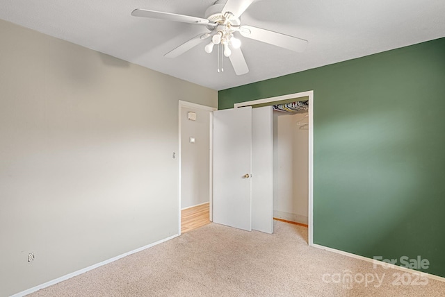 unfurnished bedroom with baseboards, a closet, carpet, and a ceiling fan