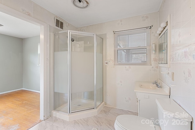 full bathroom featuring a stall shower, visible vents, toilet, and tile walls