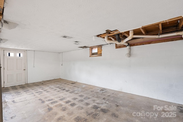 garage featuring visible vents and concrete block wall