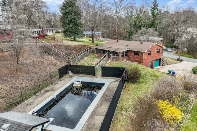 view of swimming pool with fence