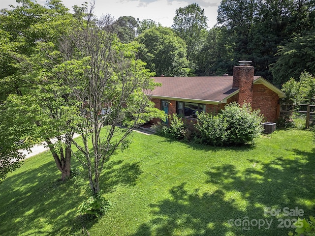 31 Vista Dr, Candler, NC 28715 - view of front of home featuring central AC, a chimney, and brick siding
