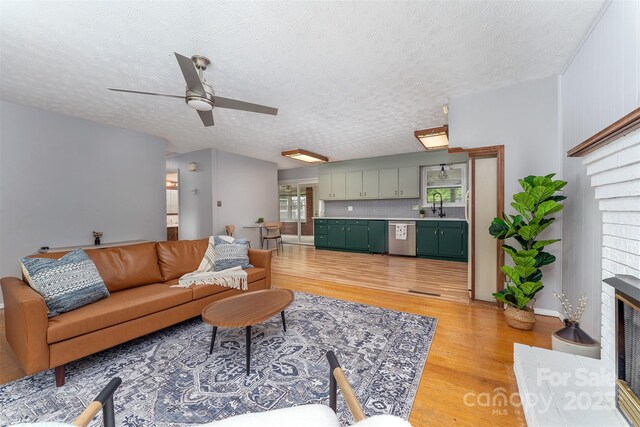 31 Vista Dr, Candler, NC 28715 - living room with light wood-style flooring, ceiling fan, and a textured ceiling