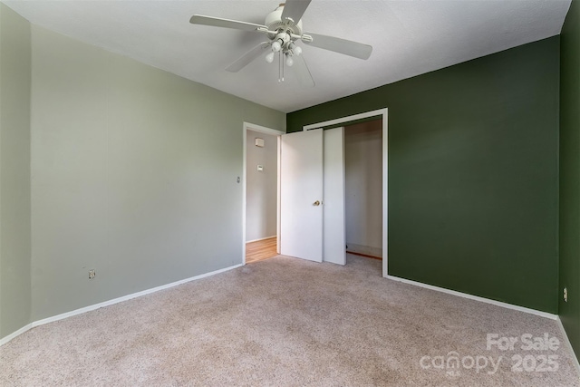 31 Vista Dr, Candler, NC 28715 - unfurnished bedroom with carpet floors, a closet, baseboards, and a ceiling fan