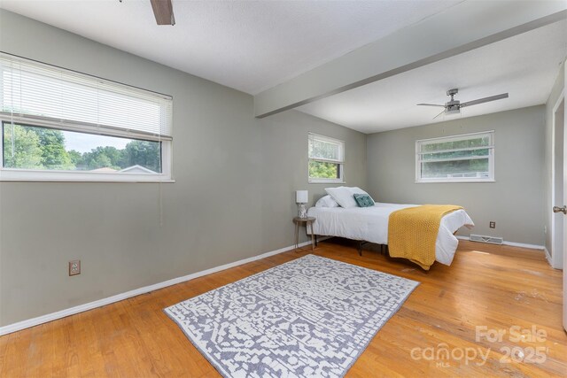 31 Vista Dr, Candler, NC 28715 - bedroom with baseboards, light wood-style flooring, ceiling fan, and beamed ceiling