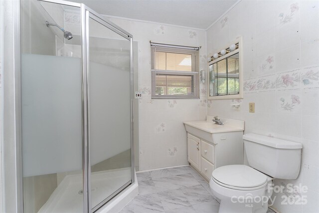 31 Vista Dr, Candler, NC 28715 - bathroom featuring ornamental molding, a shower stall, vanity, toilet, and marble finish floors