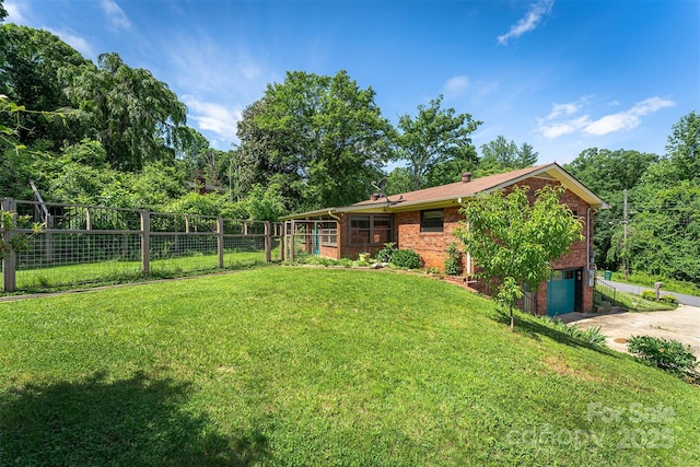 31 Vista Dr, Candler, NC 28715 - view of yard featuring an attached garage, driveway, and a sunroom