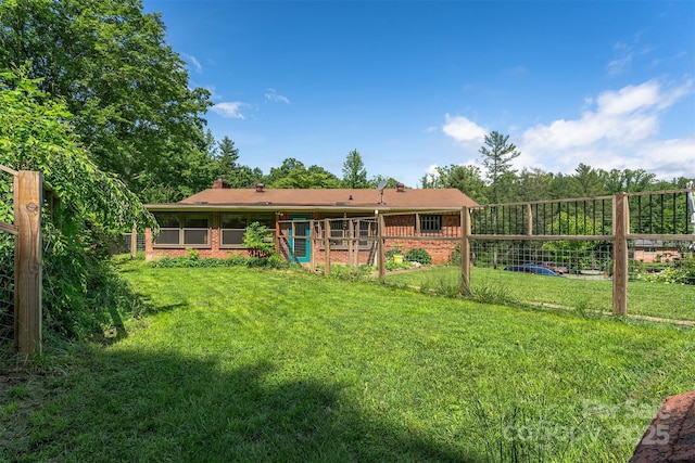 31 Vista Dr, Candler, NC 28715 - back of house featuring brick siding, a yard, and a chimney