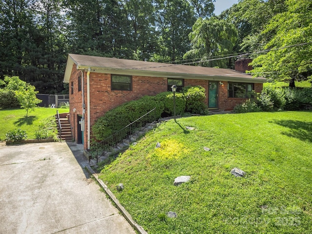 31 Vista Dr, Candler, NC 28715 - ranch-style house featuring brick siding, a front yard, stairs, and concrete driveway