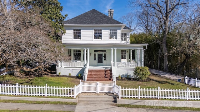 view of front facade with a gate, a fenced front yard, covered porch, and stairway