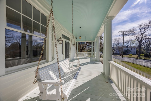 wooden terrace featuring covered porch
