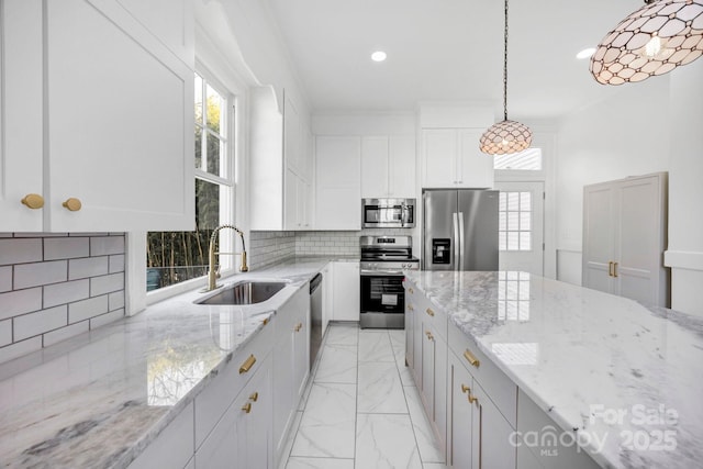 kitchen featuring a sink, decorative backsplash, stainless steel appliances, white cabinets, and marble finish floor
