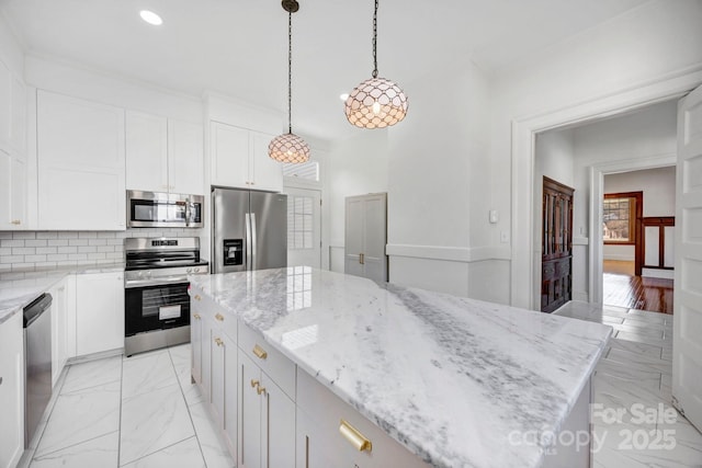 kitchen featuring marble finish floor, a kitchen island, tasteful backsplash, white cabinetry, and appliances with stainless steel finishes