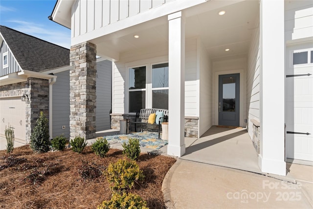 1132 Meander Ln, Waxhaw, NC 28173 - doorway to property featuring board and batten siding, stone siding, a shingled roof, and a garage