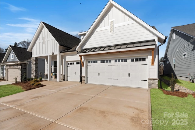 1132 Meander Ln, Waxhaw, NC 28173 - view of front of property with board and batten siding, a standing seam roof, stone siding, a garage, and concrete driveway