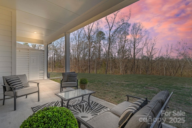 1132 Meander Ln, Waxhaw, NC 28173 - patio terrace at dusk with an outdoor hangout area, a lawn, and a patio area