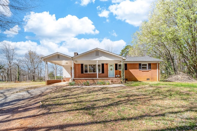 view of front of home featuring driveway, a porch, a carport, crawl space, and brick siding