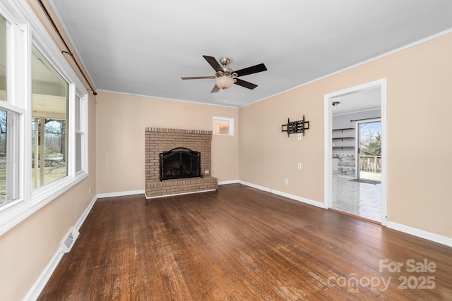 unfurnished living room featuring baseboards, wood finished floors, and a ceiling fan