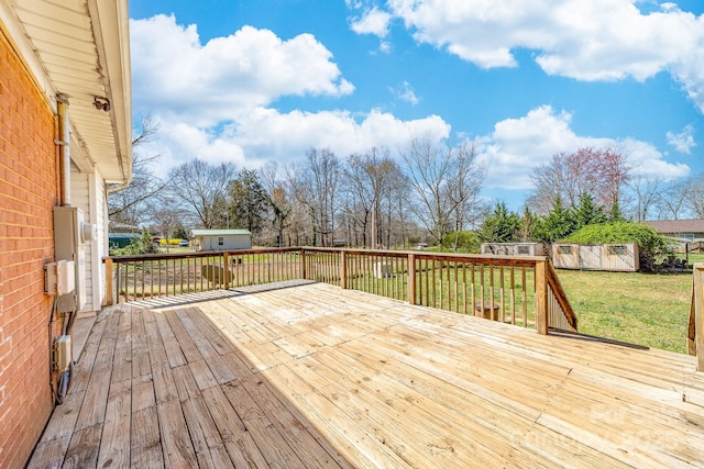 wooden terrace with an outdoor structure, a yard, and a shed