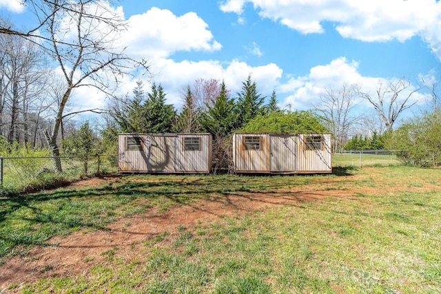 view of yard with an outbuilding, a shed, and a fenced backyard