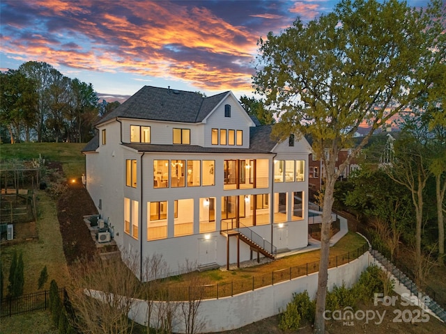 back of house with a lawn, a shingled roof, a fenced backyard, and a patio