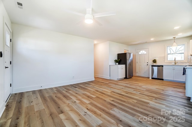 1116 Carolina Ave, Rock Hill, SC 29730 - interior space featuring a sink, light wood finished floors, baseboards, visible vents, and ceiling fan