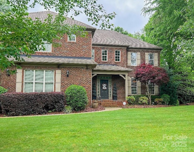 604 Wisteria Walk Way, Fort Mill, SC 29715 - view of front of home with brick siding, a front yard, and roof with shingles
