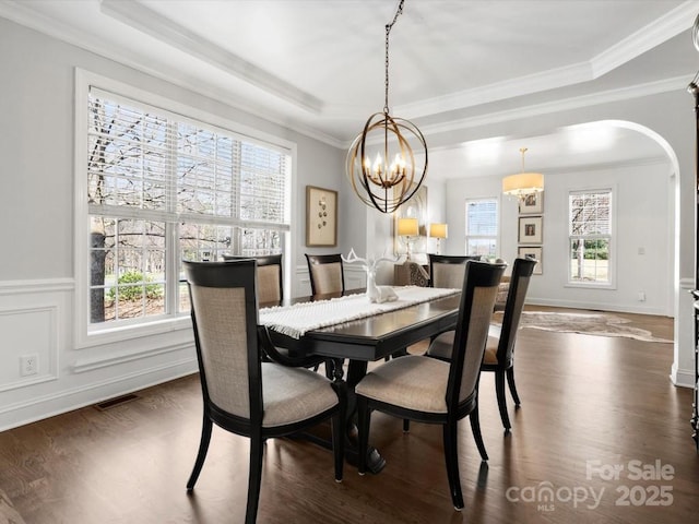 604 Wisteria Walk Way, Fort Mill, SC 29715 - dining room featuring arched walkways, a raised ceiling, crown molding, dark wood-style floors, and a chandelier
