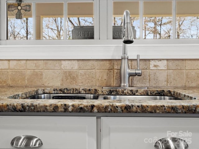604 Wisteria Walk Way, Fort Mill, SC 29715 - kitchen view of a sink, decorative backsplash, and white cabinetry