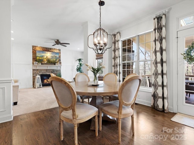 604 Wisteria Walk Way, Fort Mill, SC 29715 - dining room with ceiling fan, wood finished floors, a stone fireplace, a chandelier, and recessed lighting
