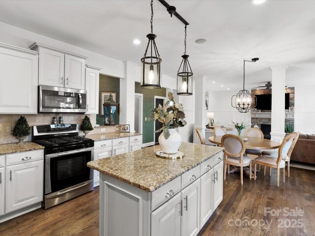 604 Wisteria Walk Way, Fort Mill, SC 29715 - kitchen with stainless steel appliances, open floor plan, recessed lighting, a center island, and white cabinets