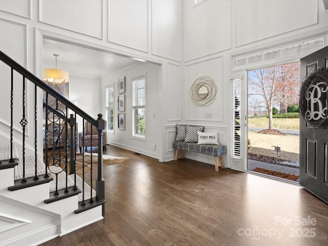604 Wisteria Walk Way, Fort Mill, SC 29715 - foyer featuring a decorative wall, stairs, a chandelier, dark wood-type flooring, and plenty of natural light