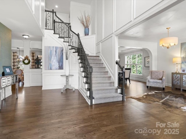 604 Wisteria Walk Way, Fort Mill, SC 29715 - foyer with stairs, a decorative wall, wood finished floors, arched walkways, and ornamental molding