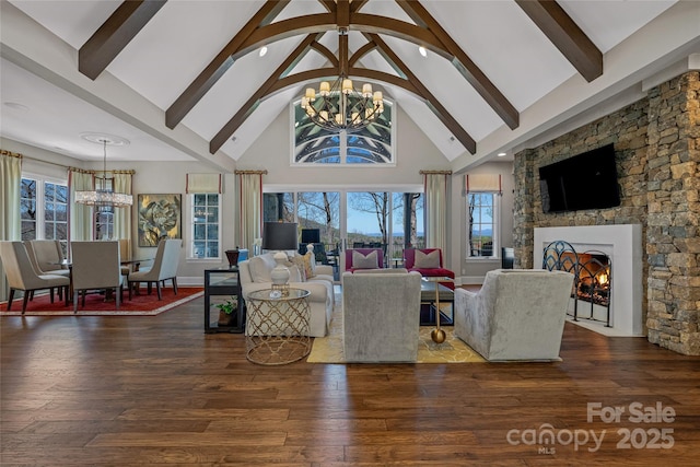 349 Stoneledge Trl, Arden, NC 28704 - living room with high vaulted ceiling, an inviting chandelier, a fireplace, wood finished floors, and beam ceiling