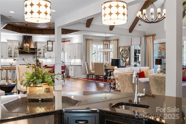 349 Stoneledge Trl, Arden, NC 28704 - kitchen featuring a chandelier, extractor fan, wood finished floors, and backsplash