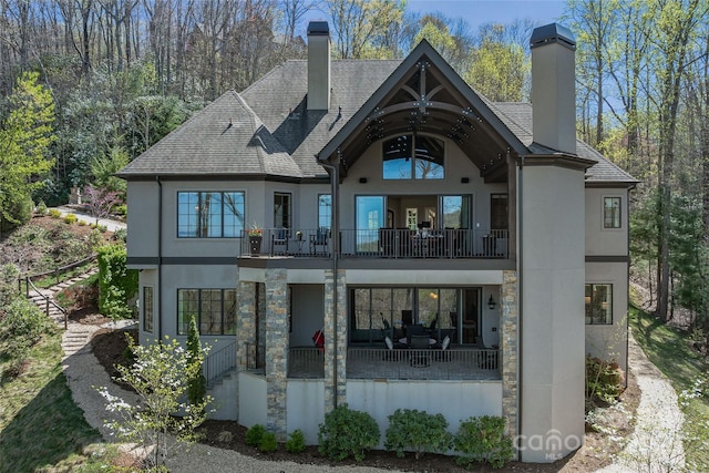 349 Stoneledge Trl, Arden, NC 28704 - rear view of property with a balcony, stucco siding, and a chimney