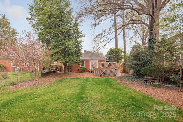 view of yard featuring fence and a wooden deck