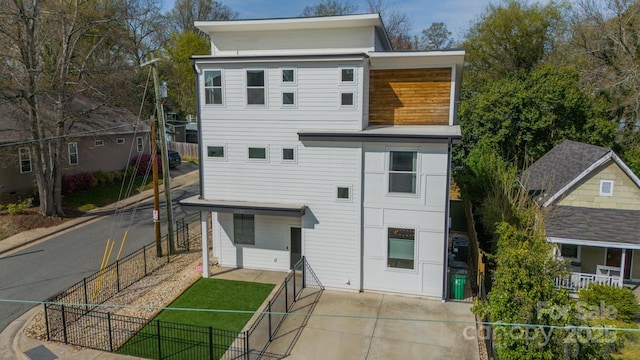 back of house with fence
