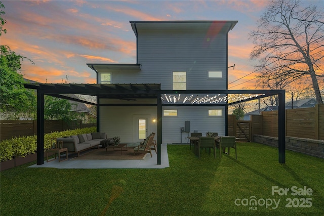 back of house at dusk featuring a patio, a fenced backyard, an outdoor living space, a pergola, and a yard