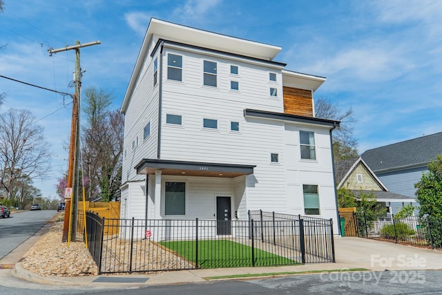 modern home featuring a fenced front yard