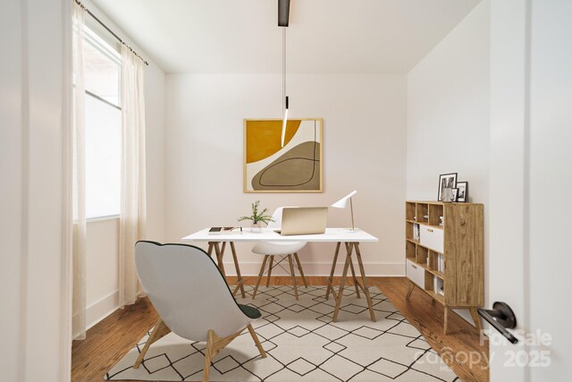 office space featuring baseboards and wood finished floors