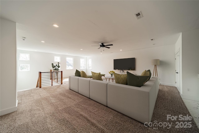 living area featuring visible vents, baseboards, recessed lighting, a ceiling fan, and carpet floors