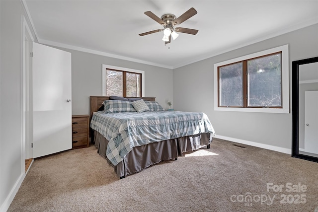 bedroom with baseboards, carpet flooring, ceiling fan, and crown molding