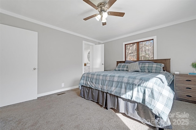 carpeted bedroom with ensuite bathroom, baseboards, visible vents, ceiling fan, and ornamental molding