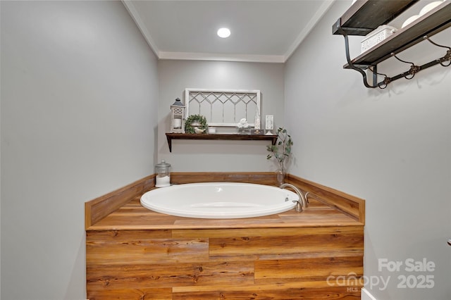 bathroom featuring a bath, ornamental molding, and recessed lighting