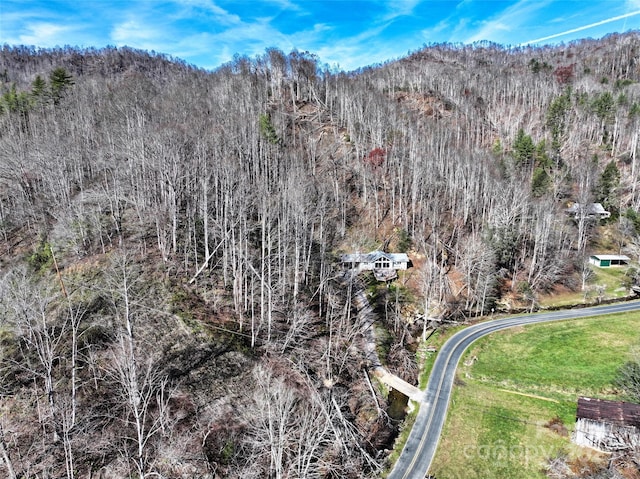 birds eye view of property featuring a wooded view