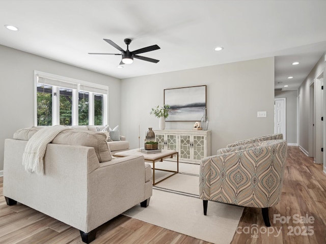 living room with a ceiling fan, recessed lighting, baseboards, and wood finished floors